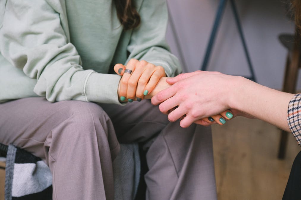 Someone reaching out for support — the first step toward recovery